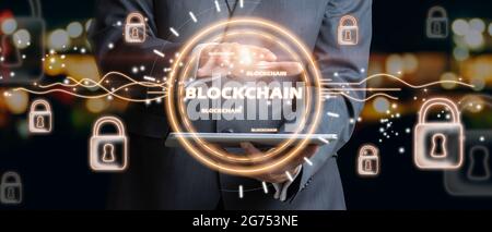 Businessman holding text blockchain in hand with lock icons locked by security. Blockchain technology and network concept Stock Photo
