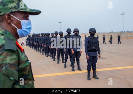 (210711) -- KIGALI, July 11, 2021 (Xinhua) -- Rwandan army and police personnel wait to board a plane for Mozambique in Kigali, capital city of Rwanda, July 10, 2021. The Rwandan government on Friday started deploying a 1000-member joint force of army and police personnel to Mozambique to support efforts to restore state authority in the latter's restive region. The deployment of the contingent comprised of members of Rwanda Defence Force and the Rwanda National Police to Cabo Delgado, Mozambique's gas-rich province that is under threat of the Islamic State-related armed groups and insurgen Stock Photo