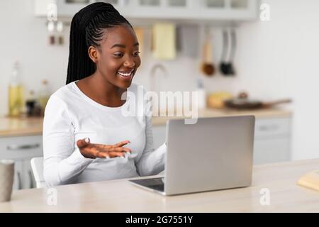 Black woman having video call using laptop and gesturing Stock Photo