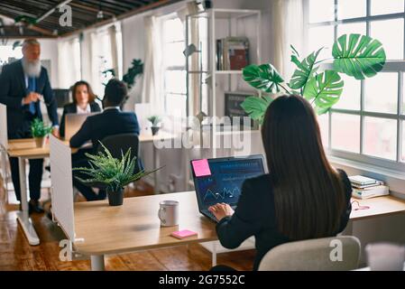 Multiracial business people working inside hedge fund office - Focus on screen Stock Photo