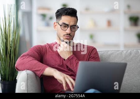 Pensive arab man freelancer working from home Stock Photo