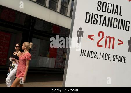 Social distancing signs are still in place outside Oxford Circus station on Oxford Street as the national coronavirus lockdown three eases towards the planned Freedom Day on 22nd July 2021 in London, United Kingdom. Now that the roadmap for coming out of the national lockdown and easing of restrictions is set, dome medical professionals are suggesting thatsome safety measures are kept in place because of the increase in the Delta variant. Stock Photo