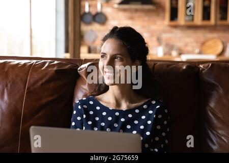 Happy female remote employee working from home Stock Photo