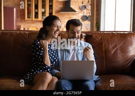 Overjoyed excited millennial couple getting good news Stock Photo