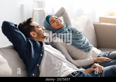Relaxed muslim family resting after moving to their new house Stock Photo