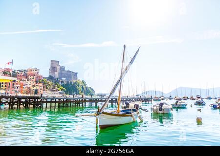 Fishing Boats in Liguria Italy. Small fishing boats with fishing equipment docked in the port - Lerici, La Spezia, Liguria, Italy Stock Photo