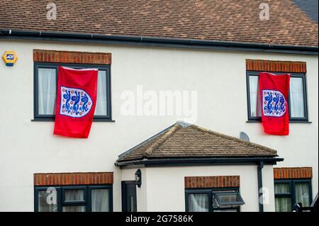 Dedworth, Windsor, Berkshire, UK. 11th July, 2021. England flags and bunting hang from houses and apartments in Dedworth Windsor ahead of tonight's UEFA Euro 2020 final between England v Italy. Credit: Maureen McLean/Alamy Live News Stock Photo