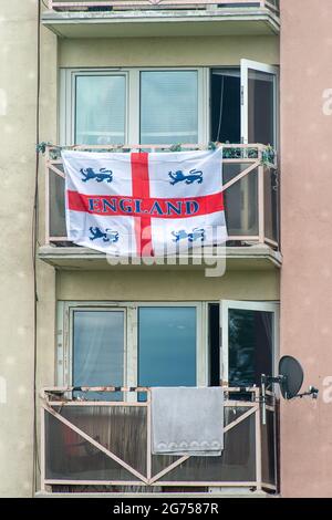 Dedworth, Windsor, Berkshire, UK. 11th July, 2021. England flags hang from balconies on a tower block in Dedworth, Windsor ahead of the UEFA Euro 2020 Final between England v Italy tonight. Credit: Maureen McLean/Alamy Live News Stock Photo