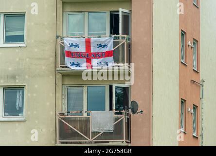 Dedworth, Windsor, Berkshire, UK. 11th July, 2021. England flags hang from balconies on a tower block in Dedworth, Windsor ahead of the UEFA Euro 2020 Final between England v Italy tonight. Credit: Maureen McLean/Alamy Live News Stock Photo