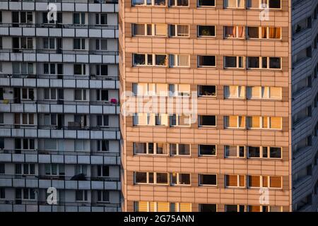Blocks of flats, city apartment tower buildings, multi-storey condominium with one facade at sunset and other in shadow, urban residential architectur Stock Photo