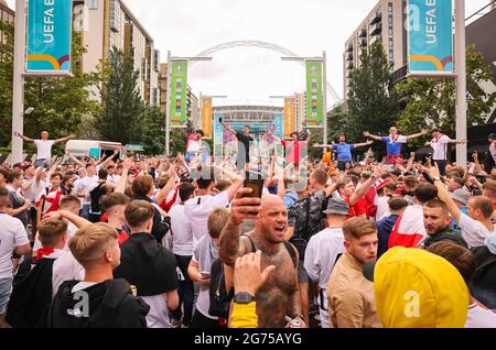 London, UK. 11th July, 2021. Football: European Championship, Italy - England, Final at Wembley Stadium. Numerous fans of England celebrate in front of the stadium in Wembley Park. Credit: Christian Charisius/dpa/Alamy Live News Stock Photo