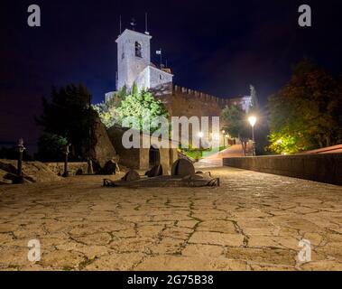 Old narrow medieval street in night illumination. San Marino. Italy. Stock Photo