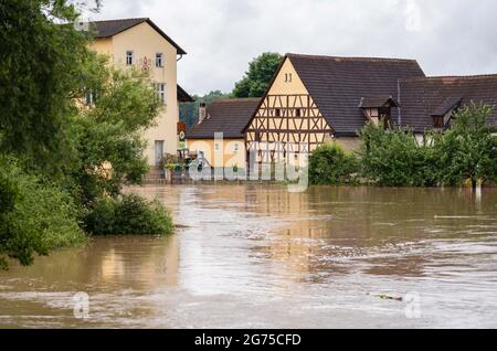 Willersdorf, Germany. 11th July, 2021. The Aisch, which has overflowed its banks, has flooded parts of Wilmersdorf. Parts of Franconia are still under water due to yesterday's high water. Credit: Nicolas Armer/dpa/Alamy Live News Stock Photo
