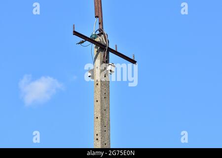 Broken electric wires on the pole and on the lamp. Summer. Stock Photo