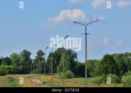 Broken electric wires on the pole and on the lamp. Summer. Stock Photo