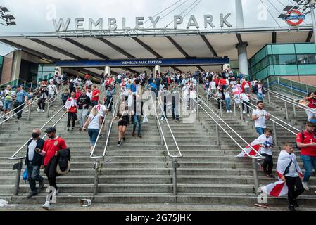 London, UK. 11th July, 2021. England fans emerge from Wembley Park tube station en route to Wembley Stadium ahead of the final of Euro 2020 between Italy and England. It is the first major final that England will have played in since winning the World Cup in 1966 and Italy remain unbeaten in their last 33 matches. Credit: Stephen Chung/Alamy Live News Stock Photo