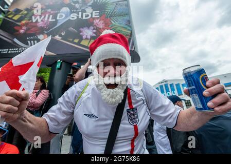 London, UK.  11 July 2021.  An England fan dressed as Father Christmas outside Wembley Stadium ahead of the final of Euro 2020 between Italy and England.  It is the first major final that England will have played in since winning the World Cup in 1966 and Italy remain unbeaten in their last 33 matches.  Credit: Stephen Chung / Alamy Live News Stock Photo