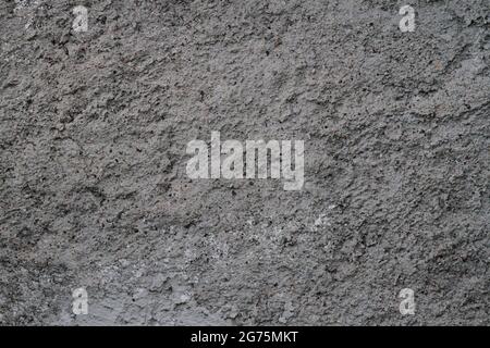 Concrete, plaster, wall covering, flooring made of small pebbles. Concrete made by mixing tiny black pebbles. Stone floor wall background brick patter Stock Photo