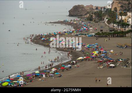 Malaga, Spain. 11th July, 2021. People cool off on the beach during a hot summer day at Rincon de la Victoria.Spain live its first heat wave with high temperatures near 45º degrees in many cities of the country, according to the Spanish Meteorological Agency. Spaniards take advantage of beaches to cool off at the Mediterranean Sea and enjoy good weather. Credit: SOPA Images Limited/Alamy Live News Stock Photo