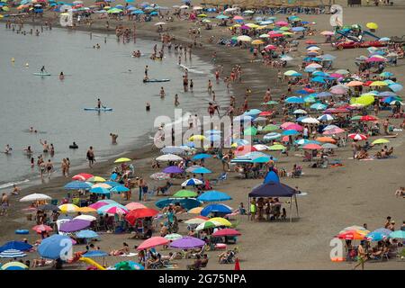 Malaga, Spain. 11th July, 2021. People cool off on the beach during a hot summer day at Rincon de la Victoria.Spain live its first heat wave with high temperatures near 45º degrees in many cities of the country, according to the Spanish Meteorological Agency. Spaniards take advantage of beaches to cool off at the Mediterranean Sea and enjoy good weather. Credit: SOPA Images Limited/Alamy Live News Stock Photo