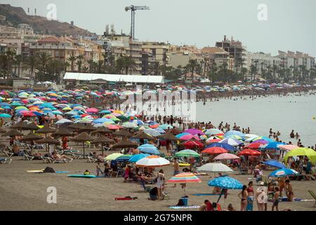 Malaga, Spain. 11th July, 2021. People cool off on the beach during a hot summer day at Rincon de la Victoria.Spain live its first heat wave with high temperatures near 45º degrees in many cities of the country, according to the Spanish Meteorological Agency. Spaniards take advantage of beaches to cool off at the Mediterranean Sea and enjoy good weather. Credit: SOPA Images Limited/Alamy Live News Stock Photo