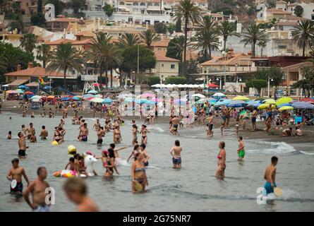 Malaga, Spain. 11th July, 2021. People cool off on the beach during a hot summer day at Rincon de la Victoria.Spain live its first heat wave with high temperatures near 45º degrees in many cities of the country, according to the Spanish Meteorological Agency. Spaniards take advantage of beaches to cool off at the Mediterranean Sea and enjoy good weather. Credit: SOPA Images Limited/Alamy Live News Stock Photo