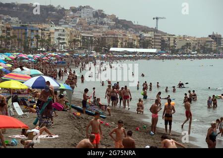 Malaga, Spain. 11th July, 2021. People cool off on the beach during a hot summer day at Rincon de la Victoria.Spain live its first heat wave with high temperatures near 45º degrees in many cities of the country, according to the Spanish Meteorological Agency. Spaniards take advantage of beaches to cool off at the Mediterranean Sea and enjoy good weather. Credit: SOPA Images Limited/Alamy Live News Stock Photo