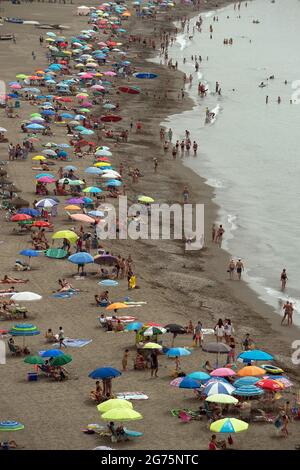 Malaga, Spain. 11th July, 2021. People cool off on the beach during a hot summer day at Rincon de la Victoria.Spain live its first heat wave with high temperatures near 45º degrees in many cities of the country, according to the Spanish Meteorological Agency. Spaniards take advantage of beaches to cool off at the Mediterranean Sea and enjoy good weather. Credit: SOPA Images Limited/Alamy Live News Stock Photo