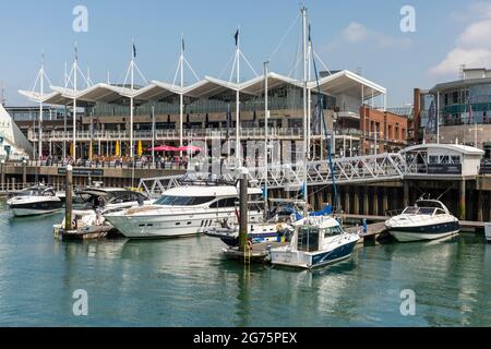 Port Portsmouth, Hampshire, England, UK. 2022. Tugs in attendace to ...