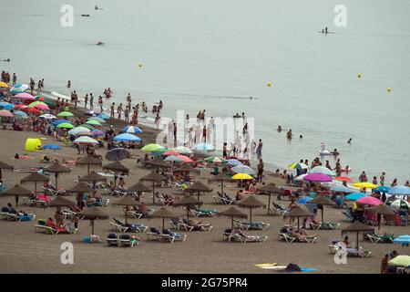 Malaga, Spain. 11th July, 2021. People cool off on the beach during a hot summer day at Rincon de la Victoria.Spain live its first heat wave with high temperatures near 45º degrees in many cities of the country, according to the Spanish Meteorological Agency. Spaniards take advantage of beaches to cool off at the Mediterranean Sea and enjoy good weather. (Photo by Jesus Merida/SOPA Images/Sipa USA) Credit: Sipa USA/Alamy Live News Stock Photo