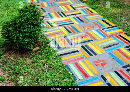 Top view on pieces of multicolored ceramic tiles decorated in garden. Old pavement of tiles textured. Street mosaic cobblestone sidewalk. Abstract,bac Stock Photo