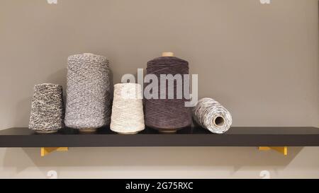 Roll of wool fiber threads, colors analogous to grey Stock Photo