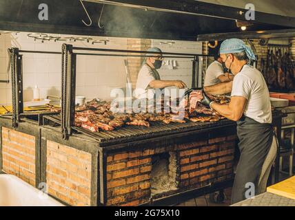 Chefs in Face Mask Cooking Meat Stock Photo