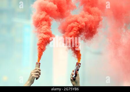 London, UK. 11th July, 2021. Flares are seen lit up outside the stadium. Scenes ahead of the UEFA Euro 2020 tournament final match, England v Italy in, London on Sunday 11th July 2021. pic by Steffan Bowen/Andrew Orchard sports photography/Alamy Live news Credit: Andrew Orchard sports photography/Alamy Live News Stock Photo