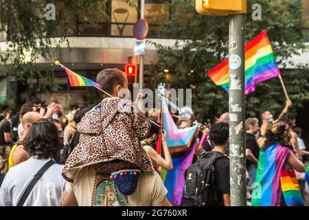 Barcelona, Catalonia, Spain. 9th July, 2021. Child is seen with an LGBT flag.Some 500 people demonstrate in Barcelona against LGTBIphobia and the death of Samuel Luiz, a 24-year-old homosexual young man murdered in a homophobic attack last week in the city of A CoruÃ±a, Spain. Credit: Thiago Prudencio/DAX/ZUMA Wire/Alamy Live News Stock Photo