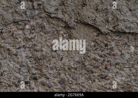 Concrete, plaster, wall covering, flooring made of small pebbles. Concrete made by mixing tiny black pebbles. Stone floor wall background brick patter Stock Photo