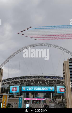 Wembley Park, UK. 11th July 2021.   Red Arrows fly over Wembley Stadium  Wembley Stadium will host the Euro 2020 Final between Italy and England this evening.  It is the first major final that England will have played in since winning the World Cup in 1966.   Amanda Rose/Alamy Live News Stock Photo