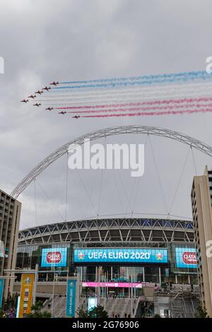 Wembley Park, UK. 11th July 2021.   Red Arrows fly over Wembley Stadium  Wembley Stadium will host the Euro 2020 Final between Italy and England this evening.  It is the first major final that England will have played in since winning the World Cup in 1966.   Amanda Rose/Alamy Live News Stock Photo