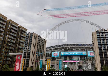 Wembley Park, UK. 11th July 2021.   Red Arrows fly over Wembley Stadium  Wembley Stadium will host the Euro 2020 Final between Italy and England this evening.  It is the first major final that England will have played in since winning the World Cup in 1966.   Amanda Rose/Alamy Live News Stock Photo