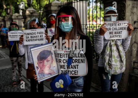 Activists carry signs as various groups protest marking the fifth and final year in office of President Rodrigo Rodrigo Duterte near the Malacanang Palace in Manila. The groups condemned the Duterte administration for its alleged human rights violation for the thousands who have been killed under the government’s war on illegal drugs and criminality including the death of activists and critics. Philippines. Stock Photo