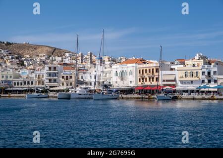Syros island, Cyclades, Greece. May 26, 2021. Destination Hermoupolis capital of Siros or Syra town background. Port with moored yachts, waterfront ca Stock Photo