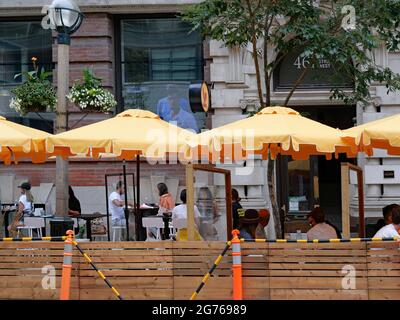 Part of the street is taken over for outdoor dining on King Street in downtown Toronto, considered safer during the pandemic. Stock Photo