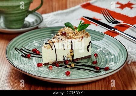Slice of cheesecake with walnuts in Georgian restaurant Stock Photo
