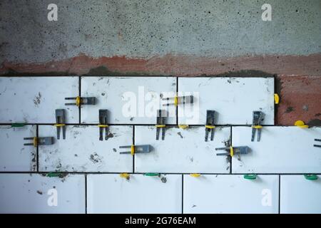 View on tile leveling system with plastic clips and wedges Stock Photo