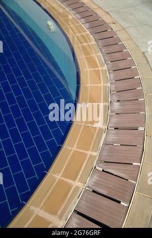 Blue clear clean water in swimming pool, tails around, arche of tails, nobody. Stock Photo