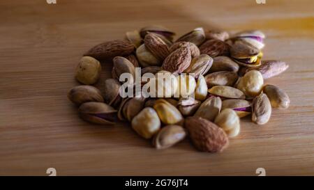 Dried fruits on a wooden background, dried nuts and fruits, selective focus Stock Photo