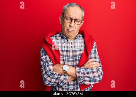 Handsome senior man with grey hair wearing casual clothes and glasses depressed and worry for distress, crying angry and afraid. sad expression. Stock Photo