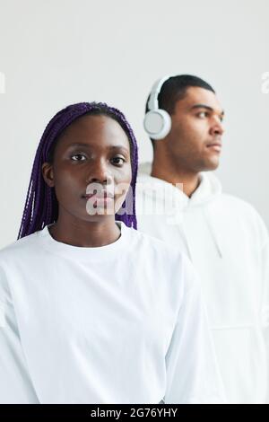 Vertical graphic portrait of young mixed race couple wearing white while posing to camera Stock Photo