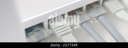White internet router with connected wires closeup Stock Photo