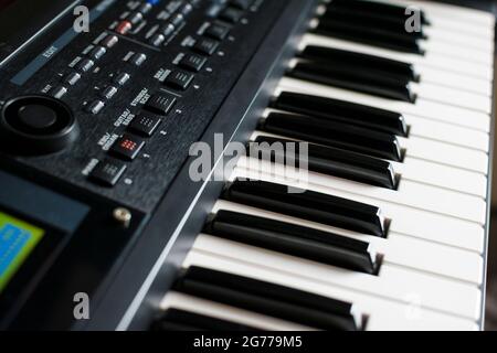 Closeup of keyboard synthesizer. Keys, buttons and knobs and the display of the instrument. Stock Photo